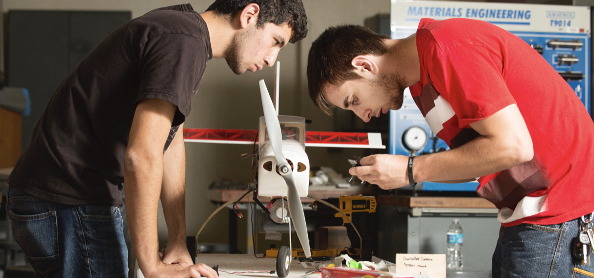 students working on model plane