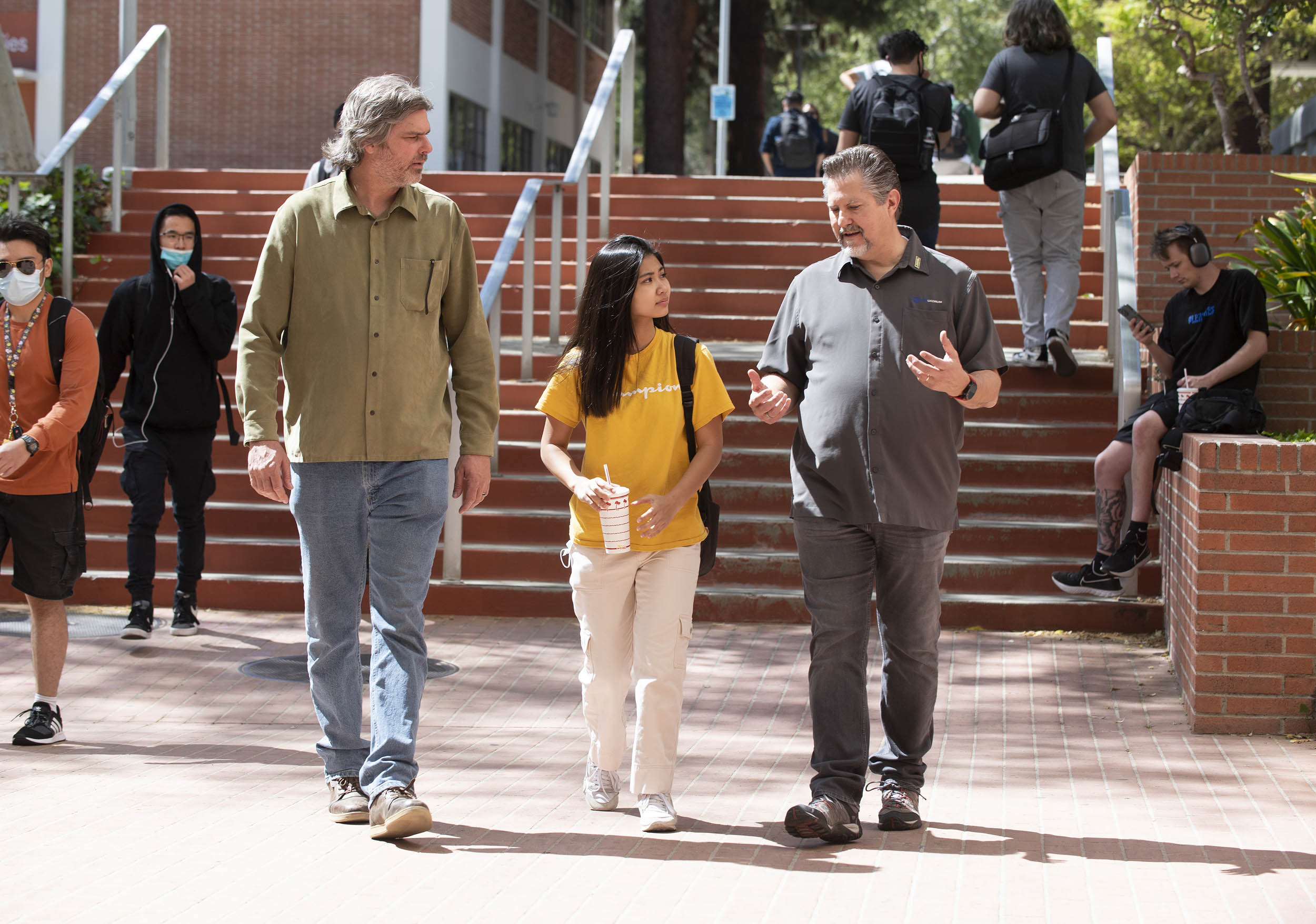 Maggie Hoang, electrical engineering student,  with Eric Schmidt (’92, aerospace engineering) (right)  and Elias Wilson (left) at the Power of Food event.