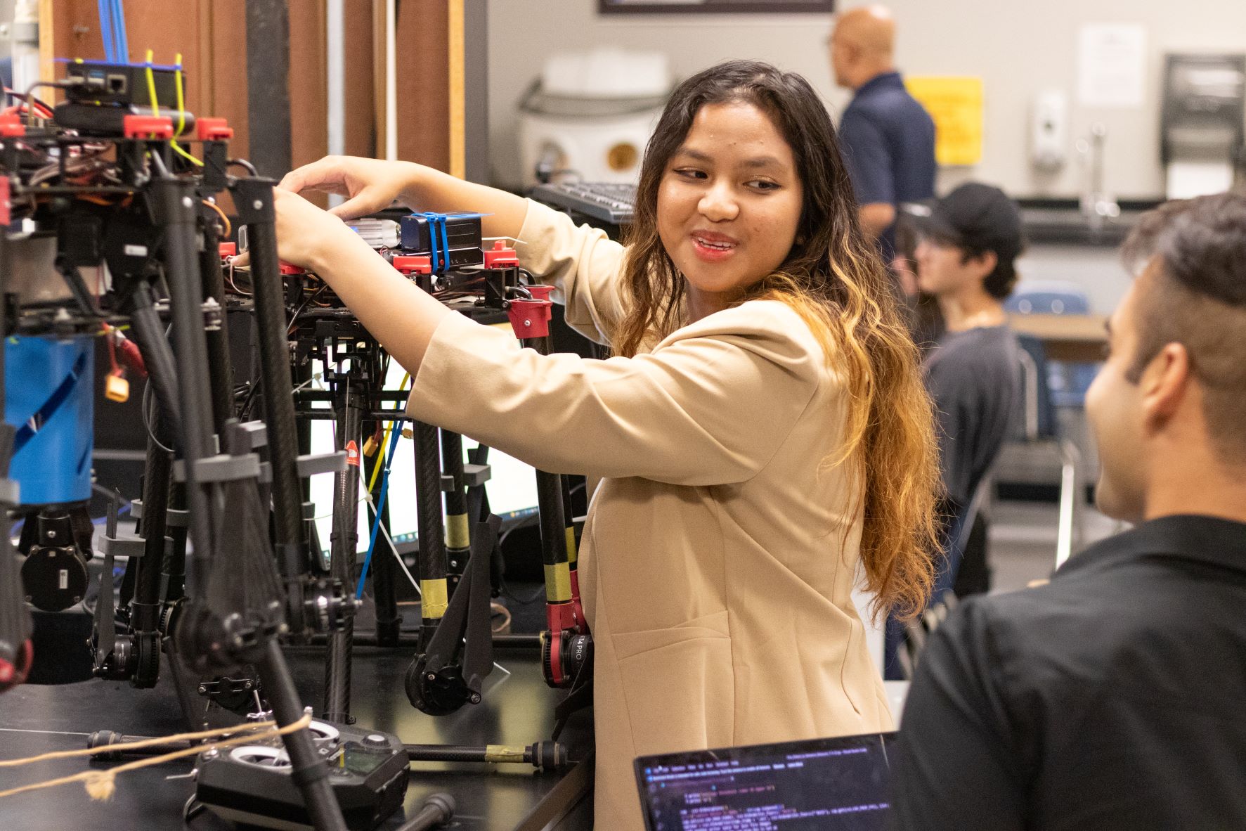 An engineering student named Eve Javier working on an unmanned autonomous vehicle.