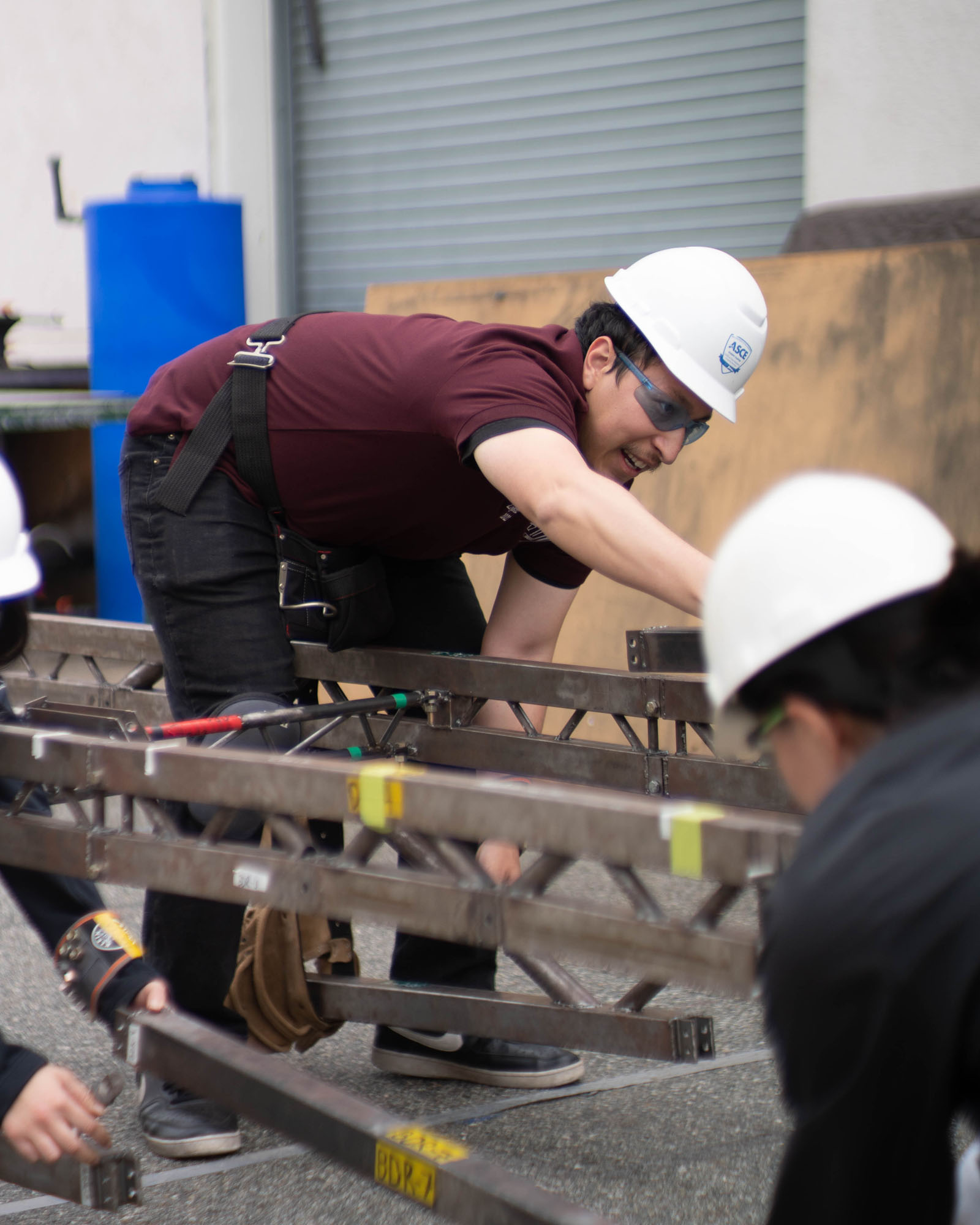 The Cal Poly Pomona Steel Bridge practicing building their bridge.