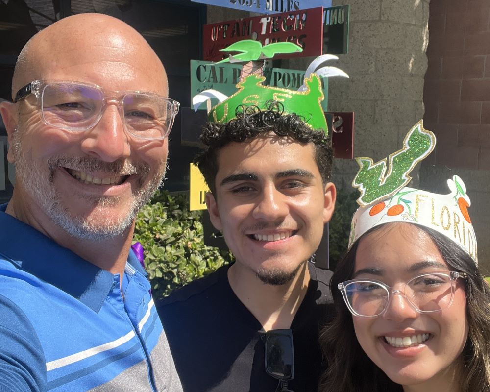 A group photo of a teacher and two of his students.