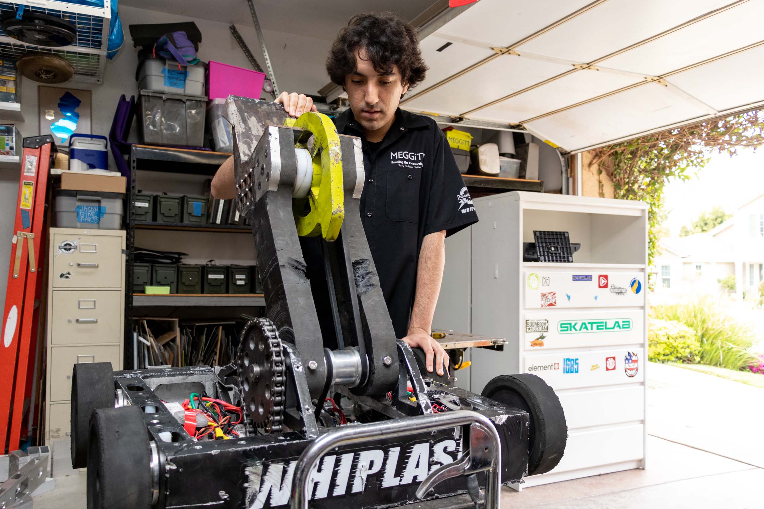 A male CPP Engineering student works on a battle robot