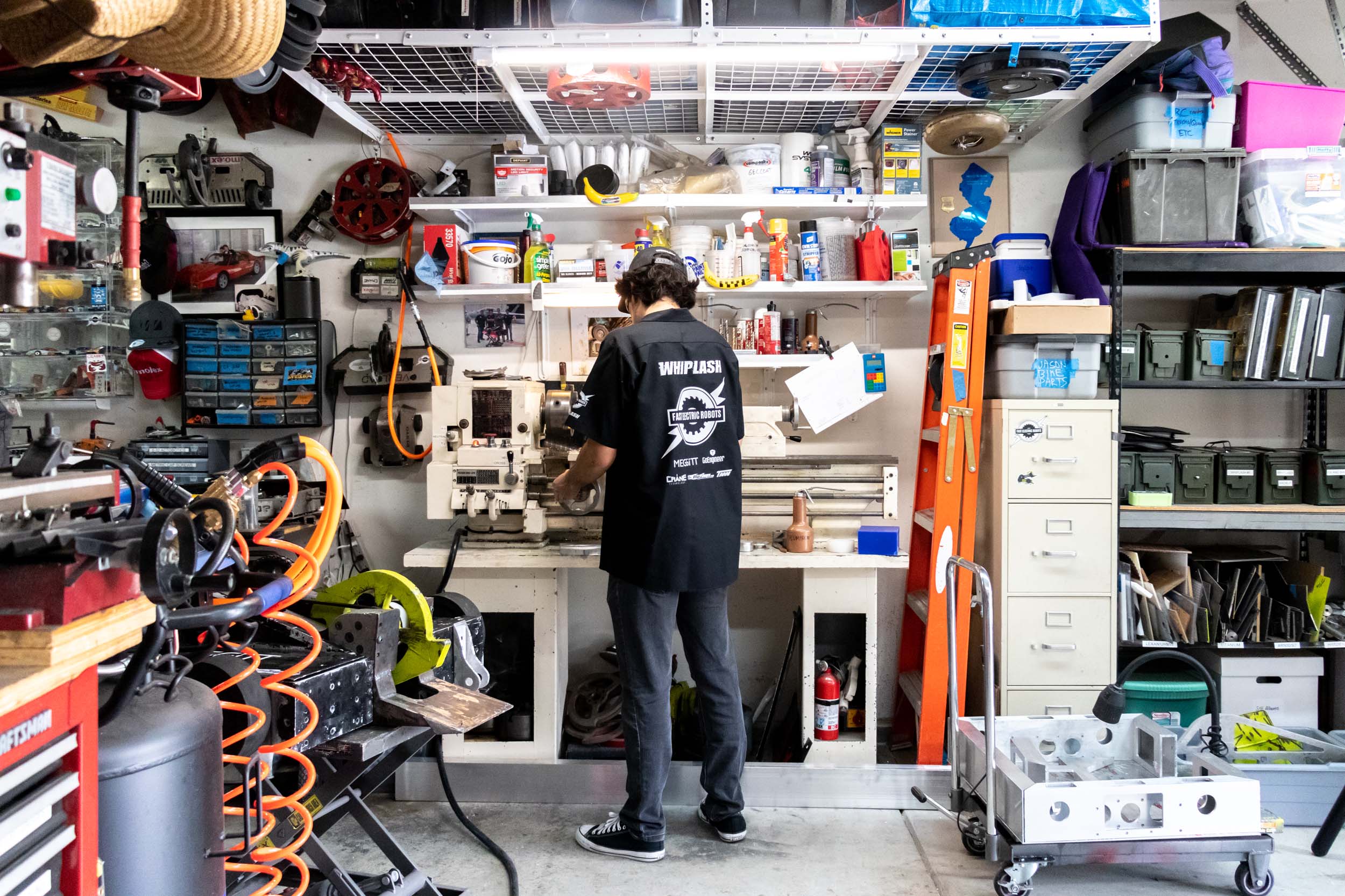 A male CPP Engineering student works in his garage.