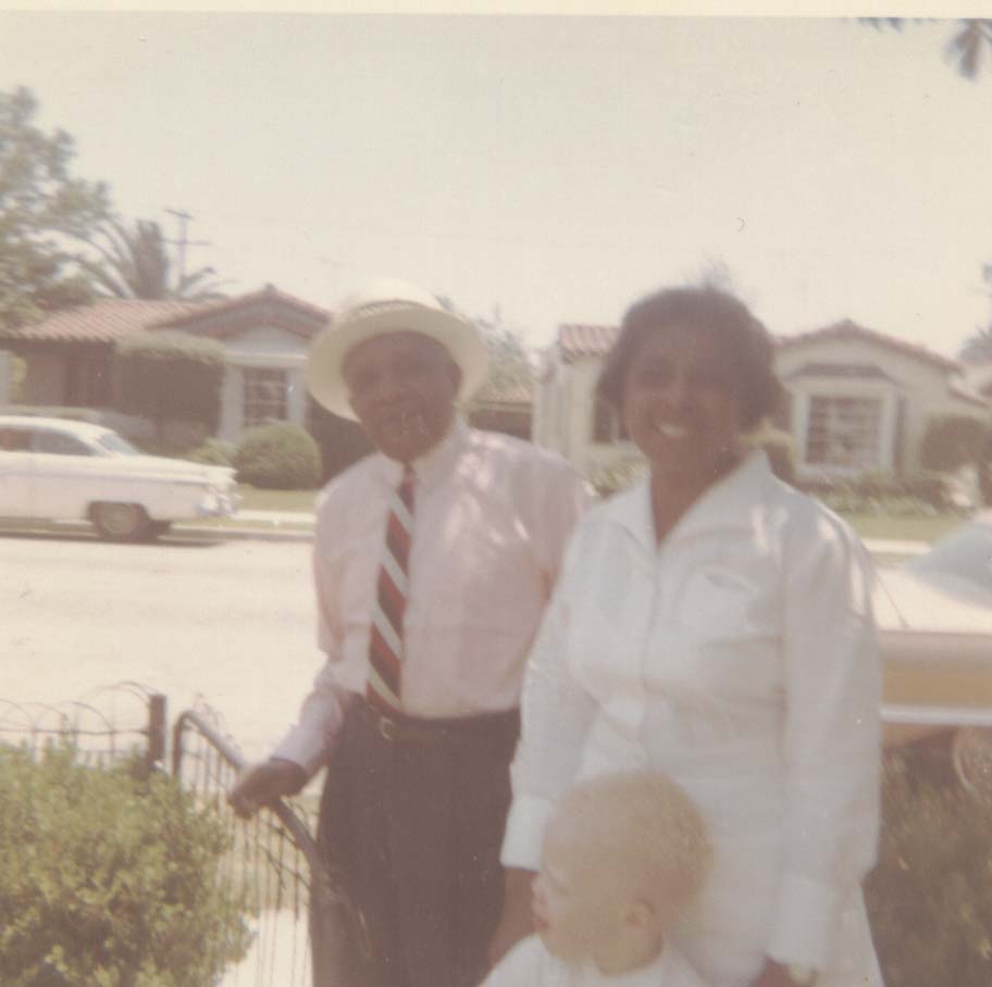 An old photo of a small child with his great grandparents.