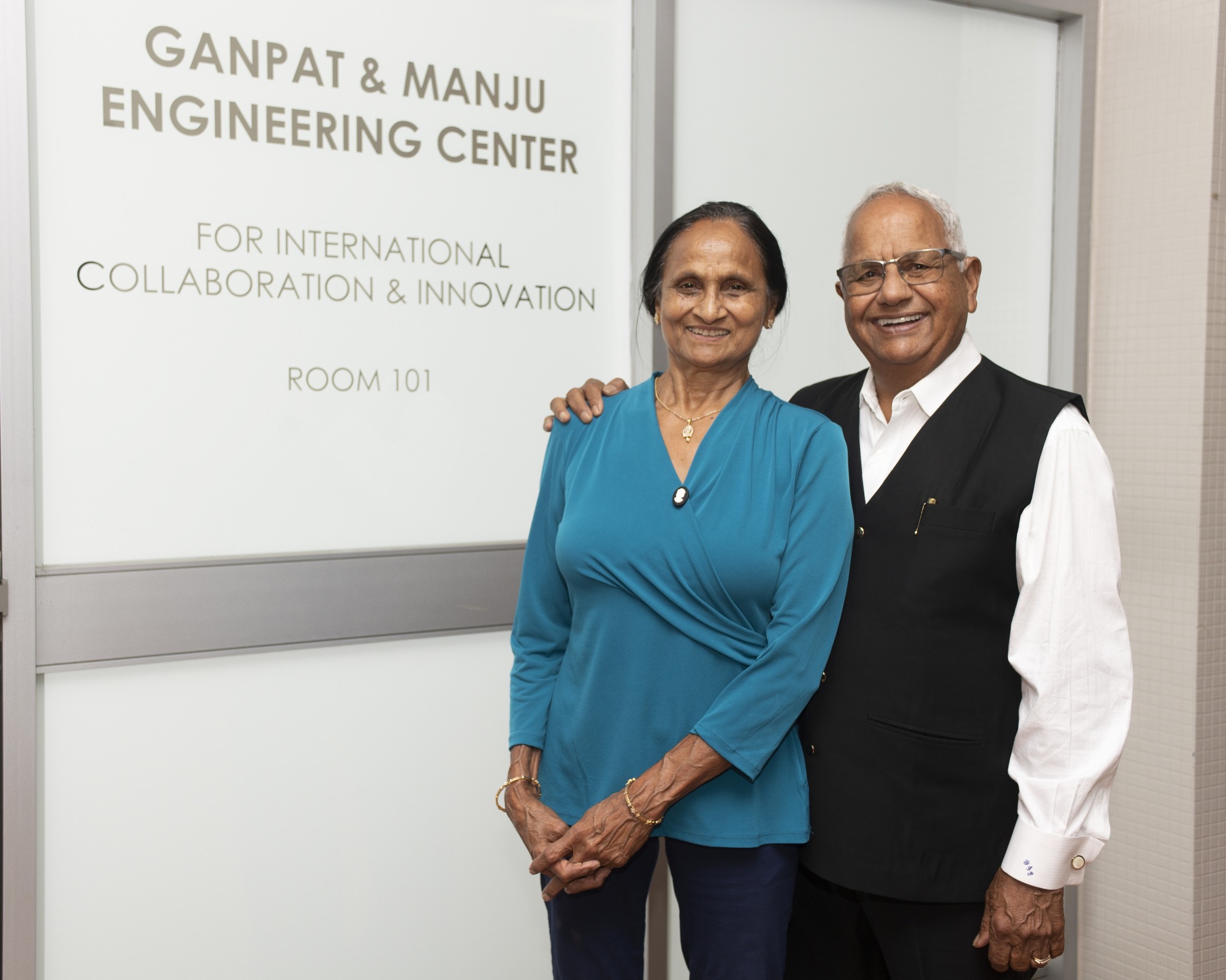 Ganpat and Manju posing in front of lab