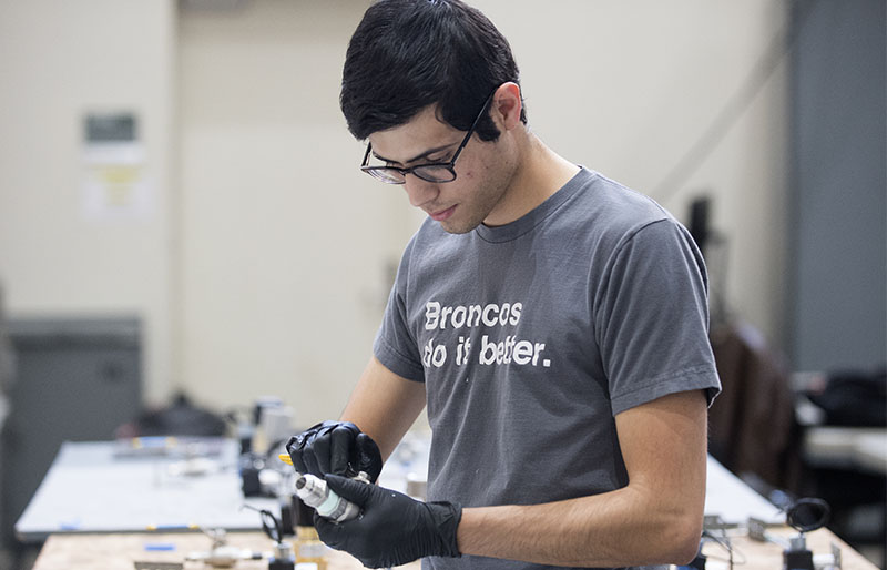 A Cal Poly Pomona engineering student with a shirt that reads Broncos Do It Better