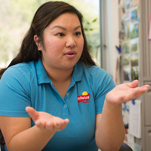 A woman with a polo with the Frito-Lay logo