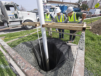 Civil engineering students working on a well.