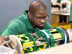 An engineering student working on a liquid rocket.
