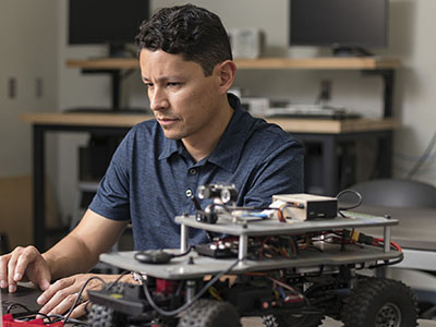 An engineering student working on his robotics project.