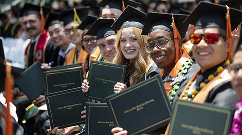 A group of students in commencement regalia