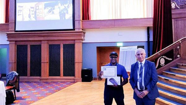 Faculty member Mohamed Aly, Ph.D., holding a certificate for an international best paper award.