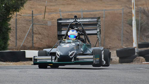 Bronco Motorsports formula car racing down a track in a competition.
