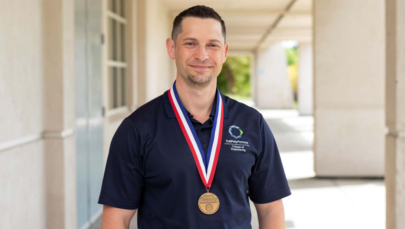 Paul Nissenson, Ph.D. He's smiling at the camera with a medal award around his neck.