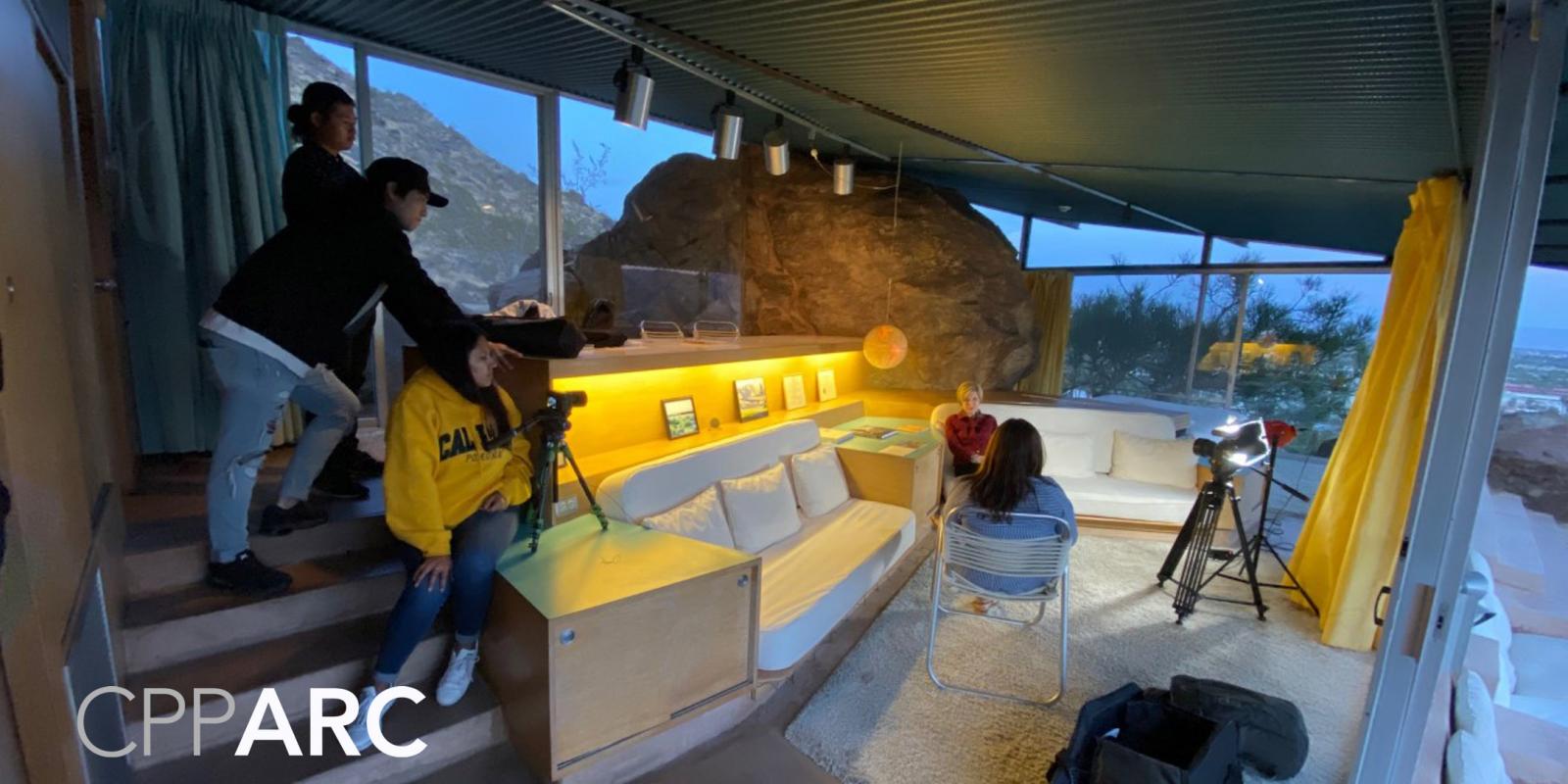 Students inside a glass-wall room