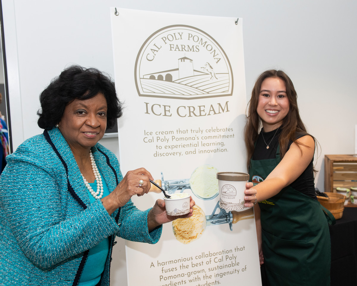 Rachel Hunter poses with President Coley, showing off the packaging design she created