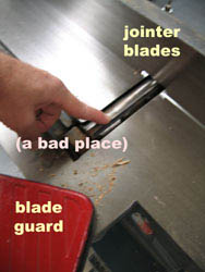 jointer showing where the jointer blades, the blade guard, and a bad place