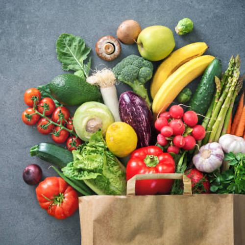 produce spilling out of brown paper grocery bag image by iStock