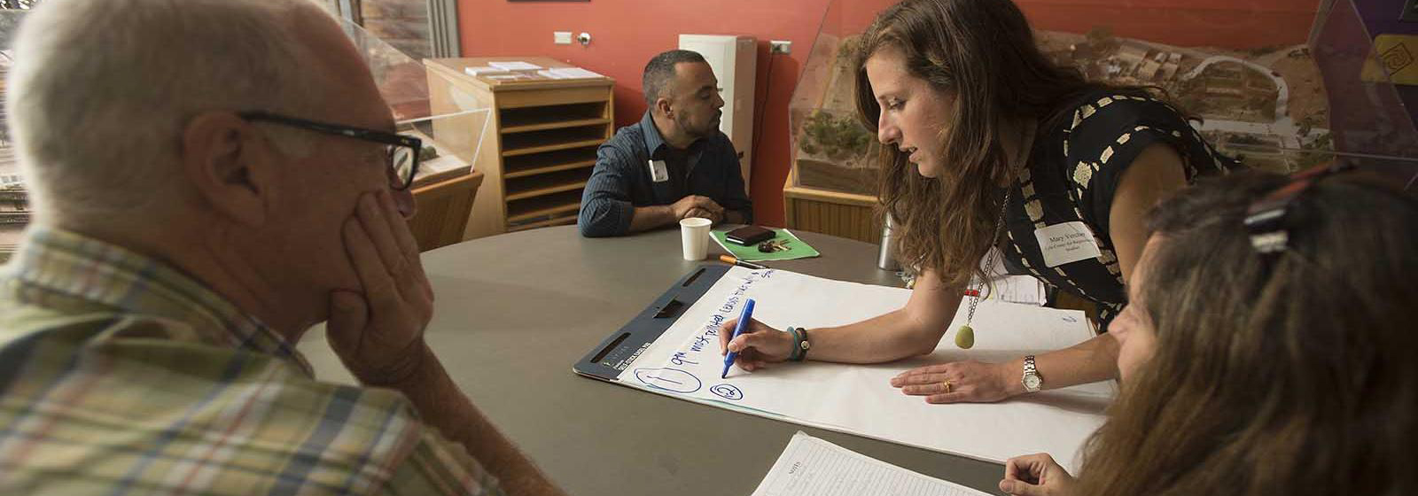 Mary Vercher writing on a notepad