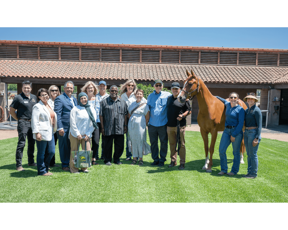 Staff Members standing with a Arabian Horse