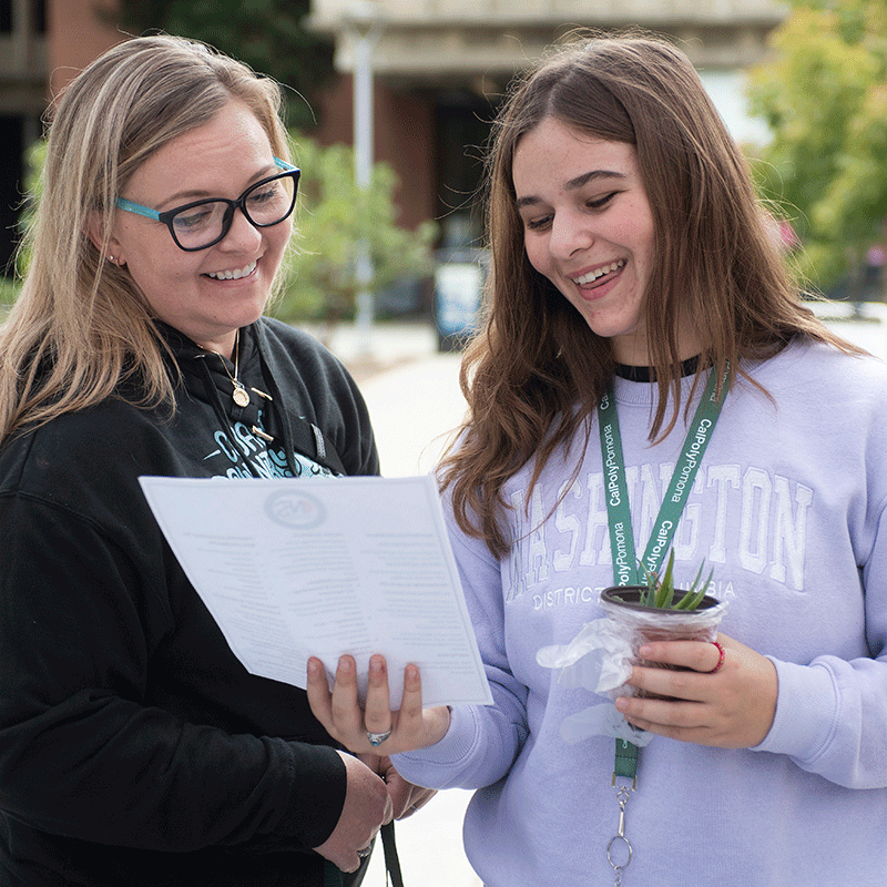 A mother and Daughter navigate campus with a map