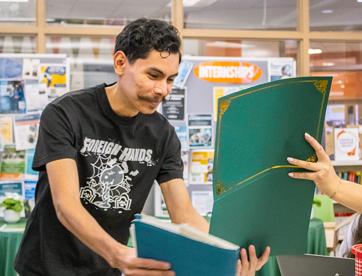 A student smiles in reaction to receiving an On-the-Spot Admission certificate.