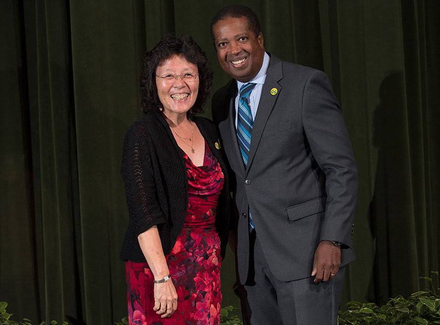 John McGuthry and a staff member receiving her award.