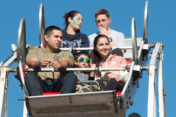 Families ride the Ferris wheel during Bronco Family Day