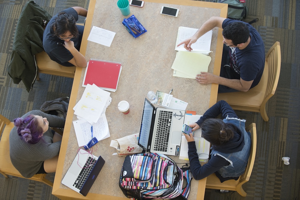 Students study at the library on their laptops