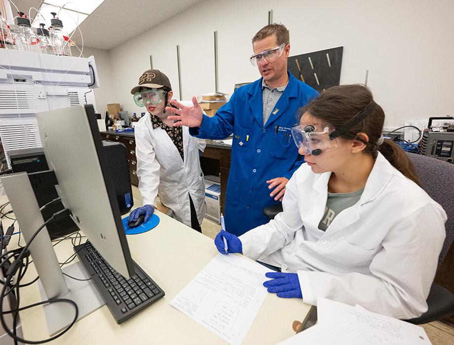 Gregory Barding (center), professor and chair of the Department of Chemistry and Biochemistry with two students