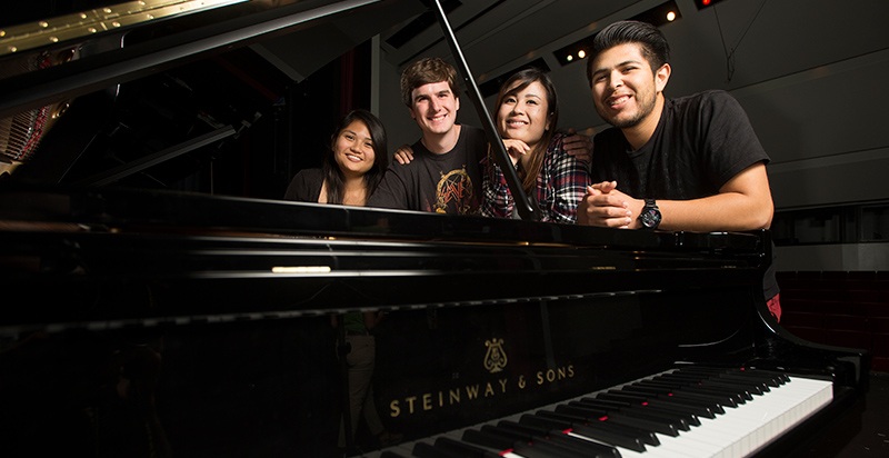 music students by a piano