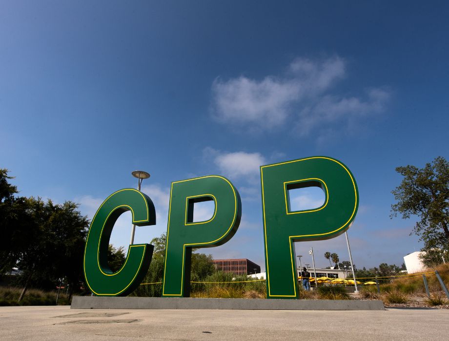 Outdoor green “CPP” sign under a blue sky.