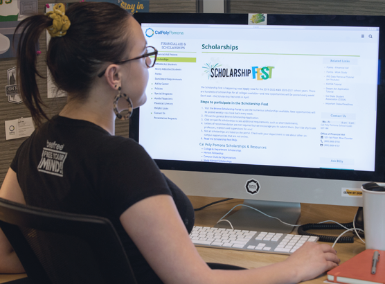 Girl on computer with Bronco Scholarship on screen