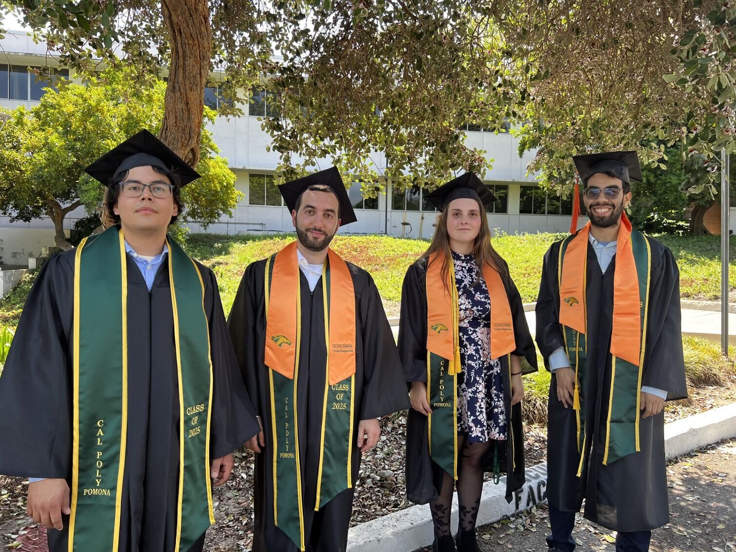 Team Aldhani posing for a photo in their graduation stoles.