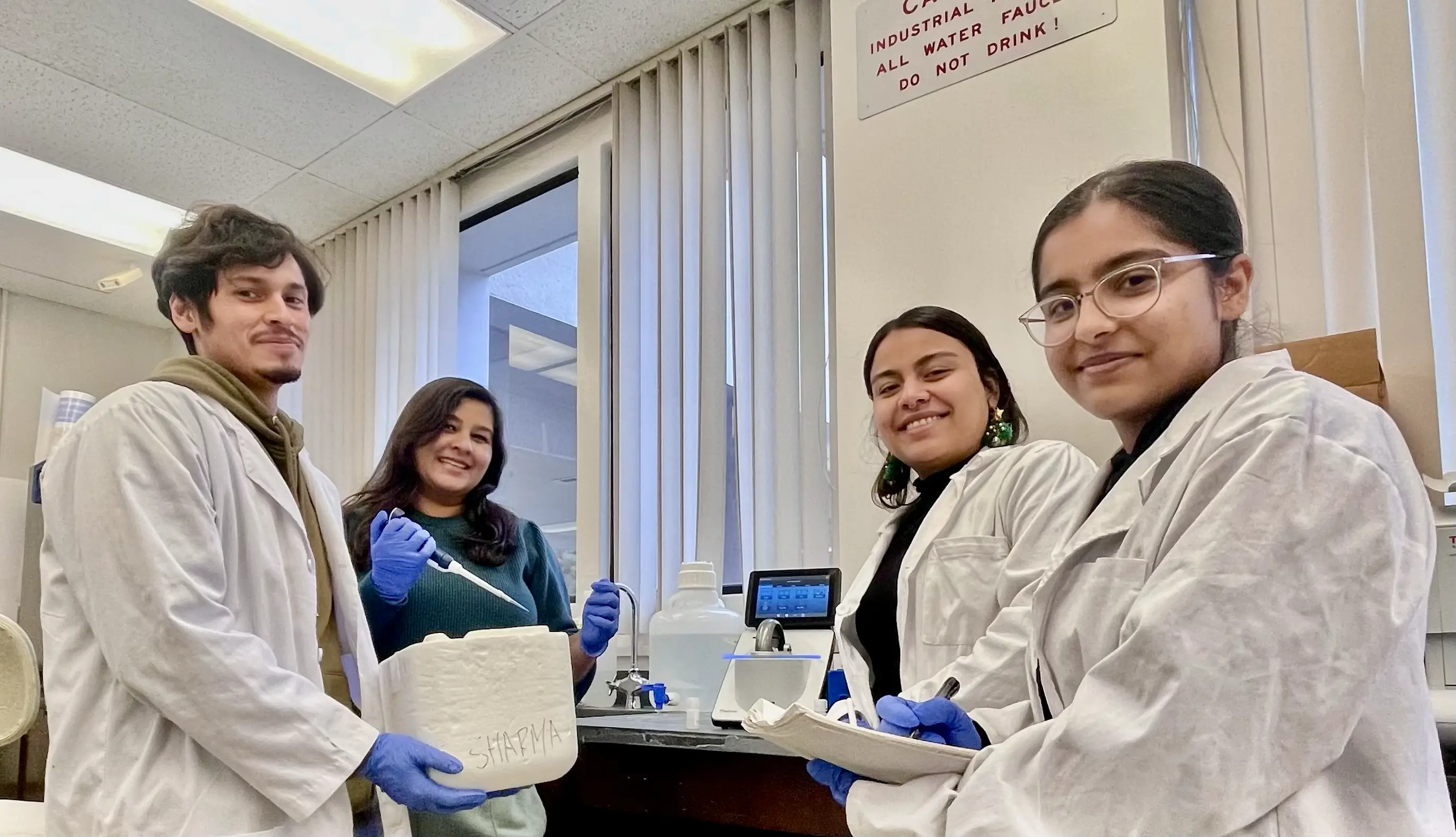 Team Buttercups posing for a team photo in a lab.