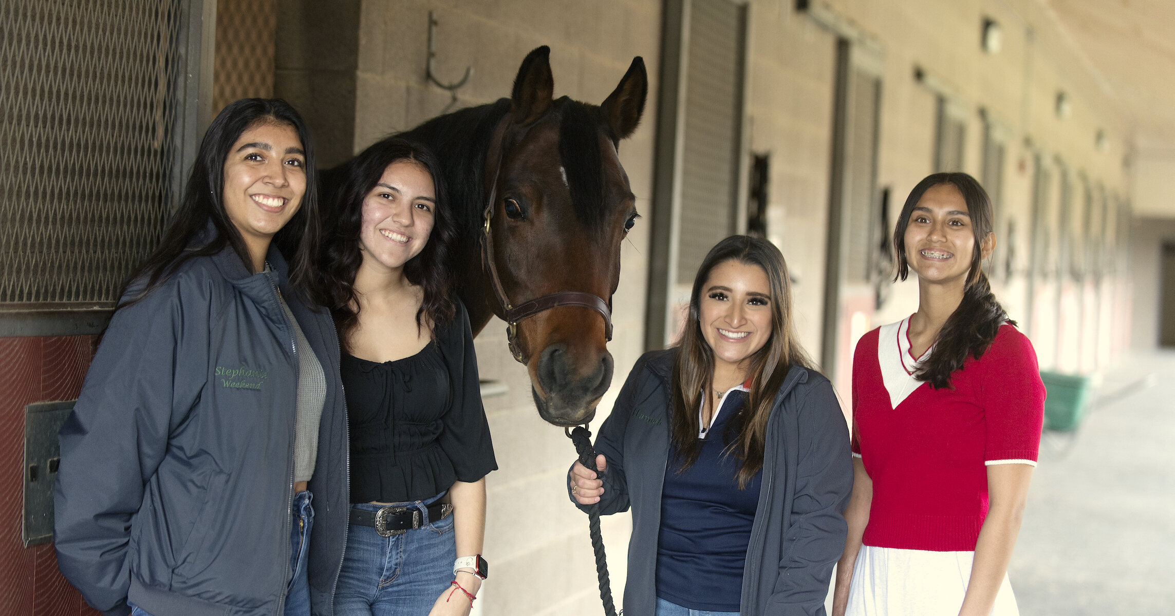 Team Horse Wellness posing for a photo together with a horse.