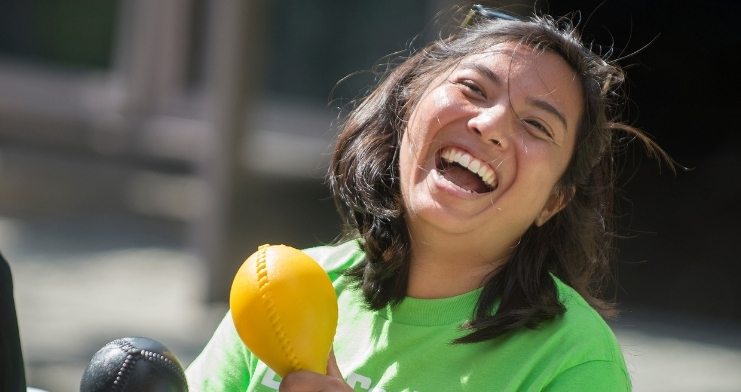 A student plays a musical instrument during an event on campus