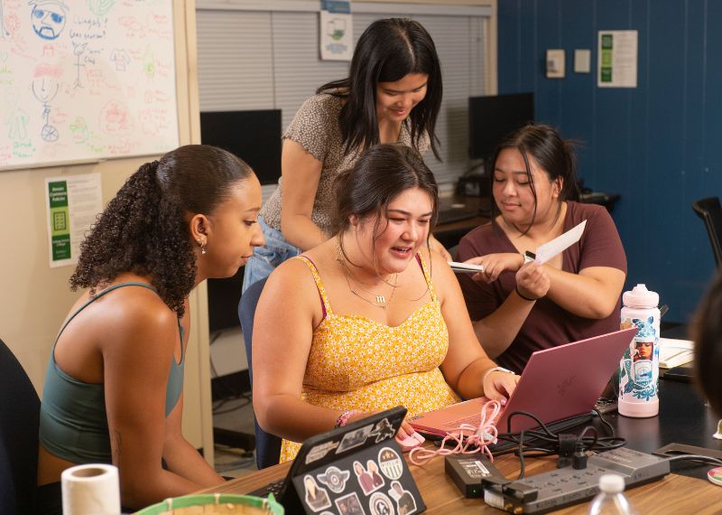 group of cpp students surrounding a computer