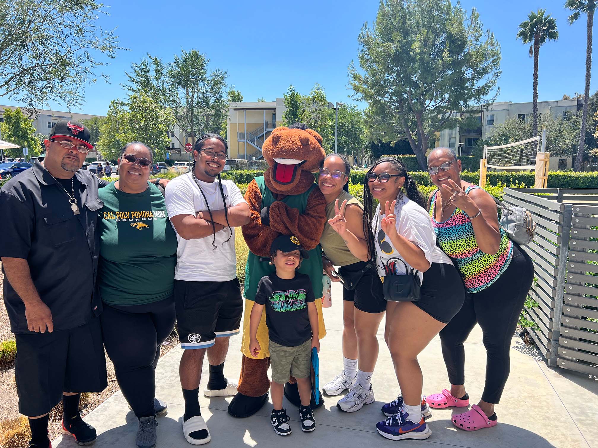Family posing with Billy Bronco at Move-In