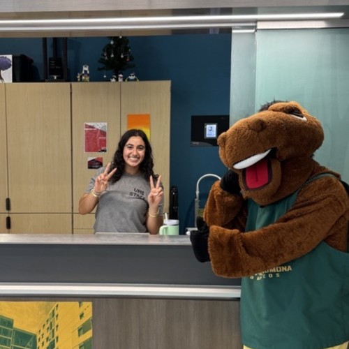 Student and mascot posing