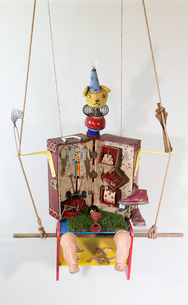Gina M.  Baby Bare from the Toy Box Kids Series, 2019  doll box, rope, found puppets and toys  68 x 38 x 28”  Courtesy of the artist