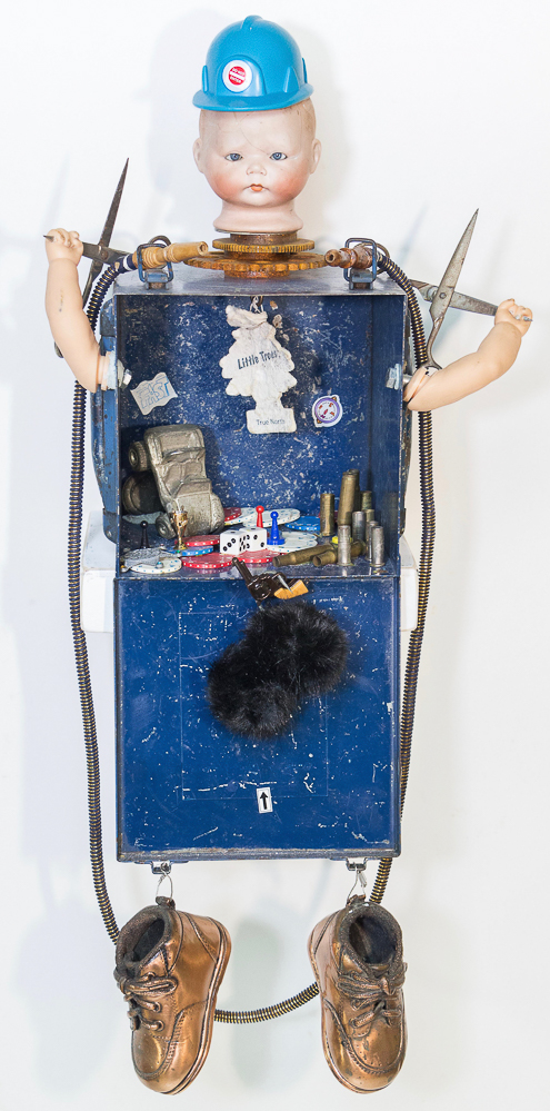 Gina M.  Runs With Scissors from the Toy Box Kids Series, 2018  assemblage, blue box, doll head, scissors, bullets, air freshener, bronze baby shoes  31 x 14 x 12”  Courtesy of the artist