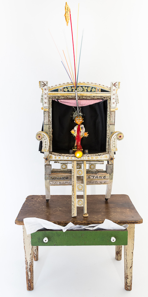 Gina M.  Whirled Stage from the Toy Box Kids Series, 2018  assemblage, child desk, puppet, paper, spotlights, found objects  62 x 36 x 20"  Courtesy of the artist