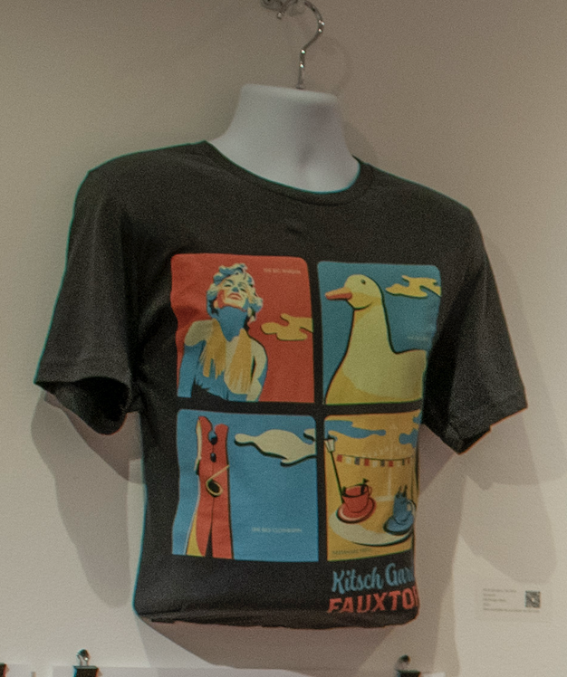 T-shirt with Marilyn Monroe, Duck, Clothespin Sculpture, and Teacup ride graphics and text "Kitsch Gardens Fauxtopia" 