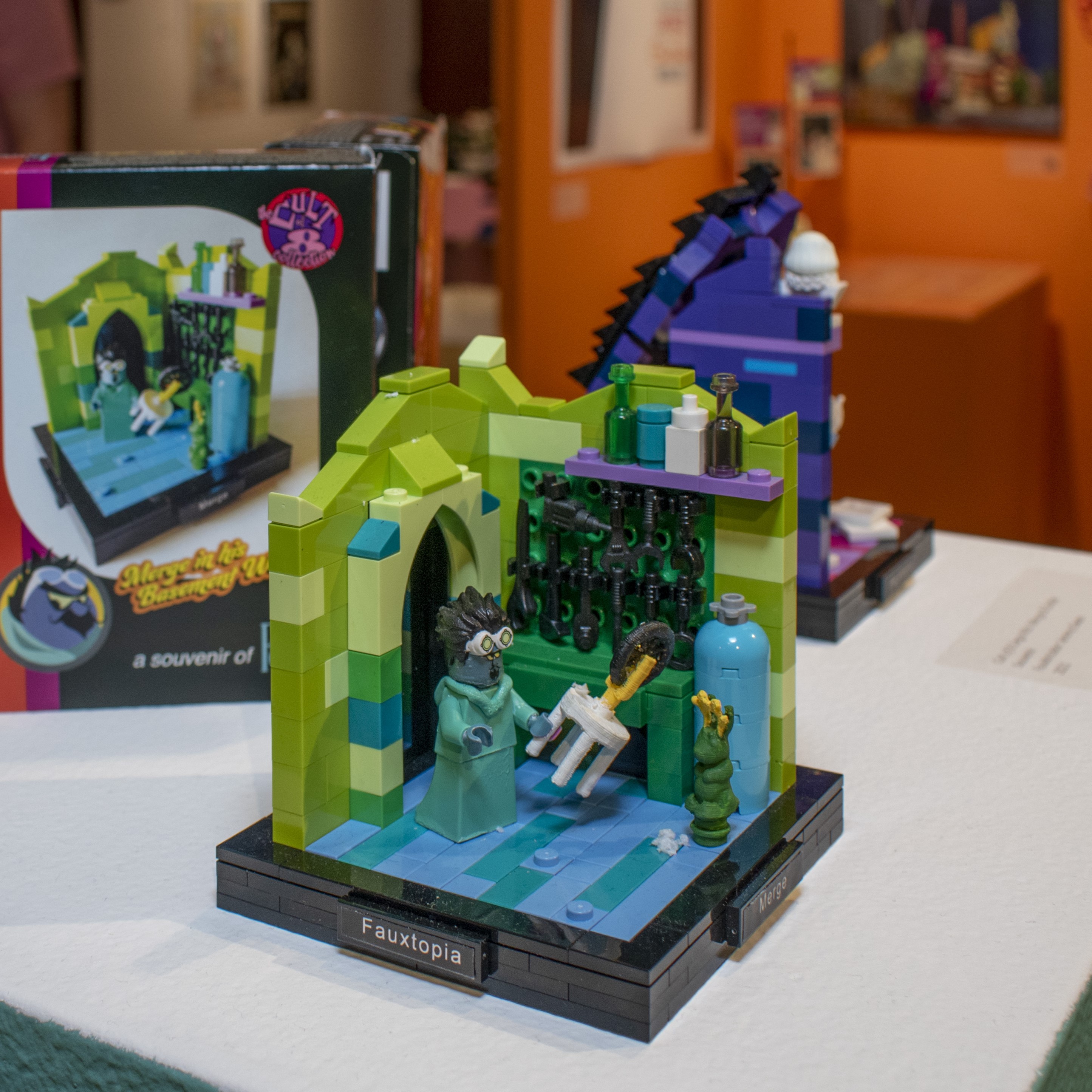Image of Lego display of scribe on a rocking chair in a purple house