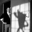 Image of a man standing next to the shadow of Blank the character 