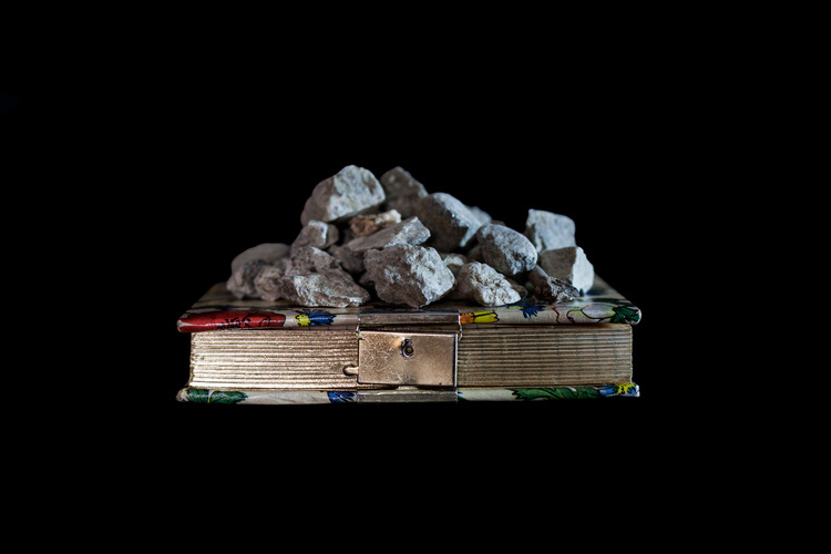book with rock on top of it