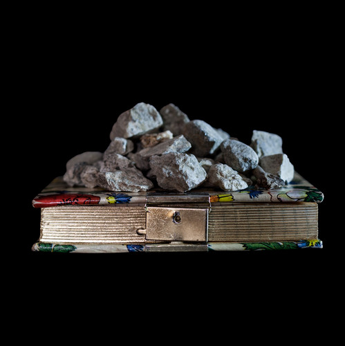 book with rock on top of it