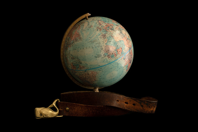 world globe with a belt around the base