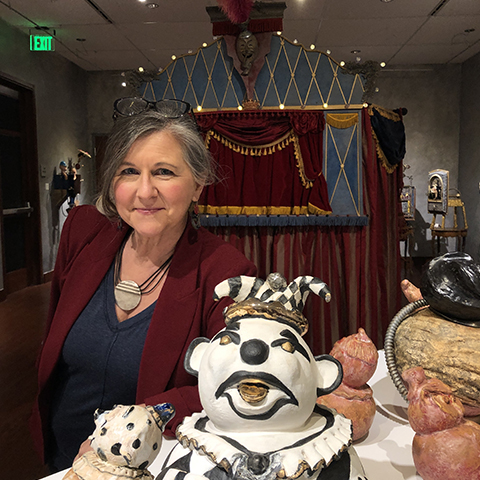 Gina M posing with sculpted exhibits